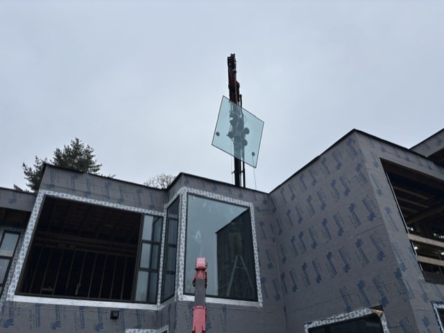 Compact crane lifting Large heavy Window into Place